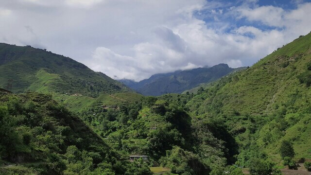 mountain range covered in green trees and bushes in chakrata