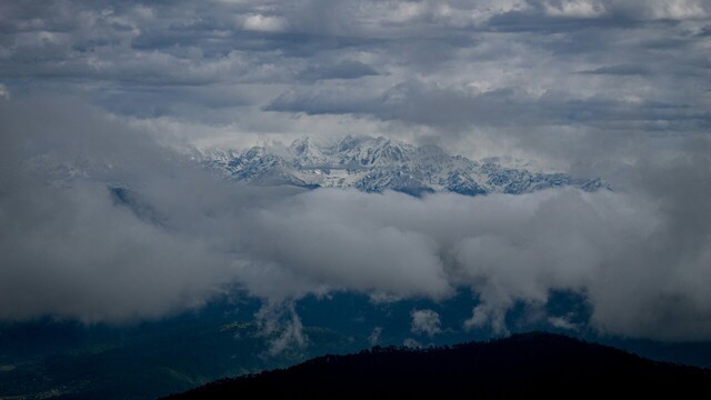 clouds covering view of mountains in distance in kausani