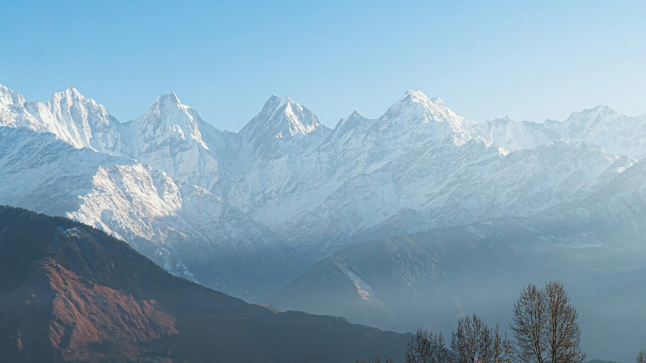 snow covered mountains in the distance in munsiyari