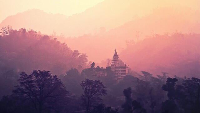 a tranquil temple nestled in the mountains bathed by sunset in rishikesh