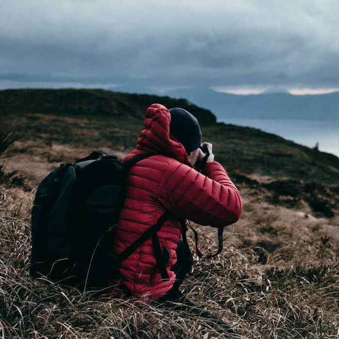 photographer clicking photo on a mountain